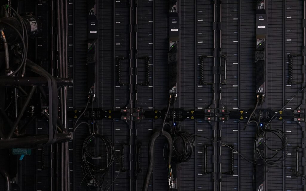 Black cables and wires connected to the back of modular LED display panels