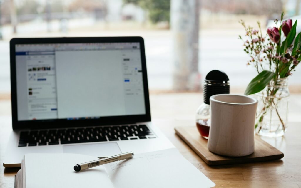 MacBook Pro near white open book