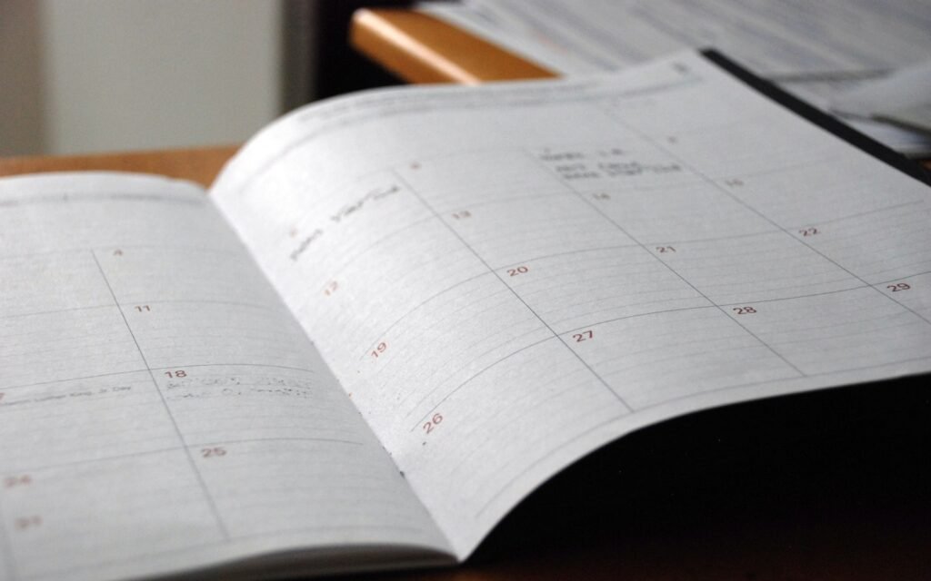 Open monthly planner on wooden desk
