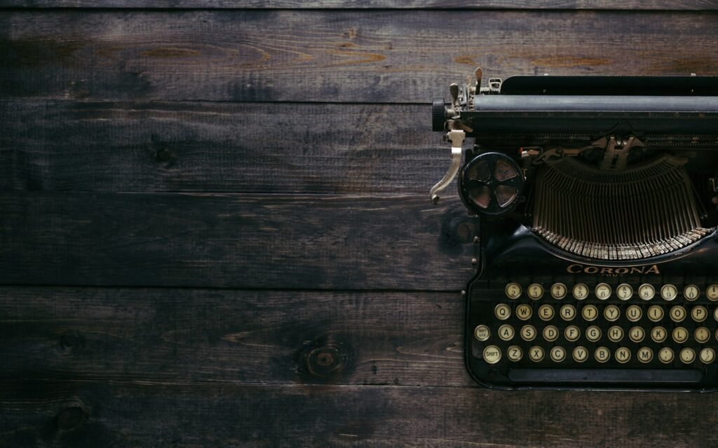 Black Corona typewriter on brown wood planks