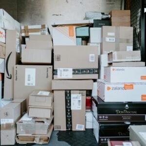 A stack of cardboard shipping boxes inside the back of a delivery van