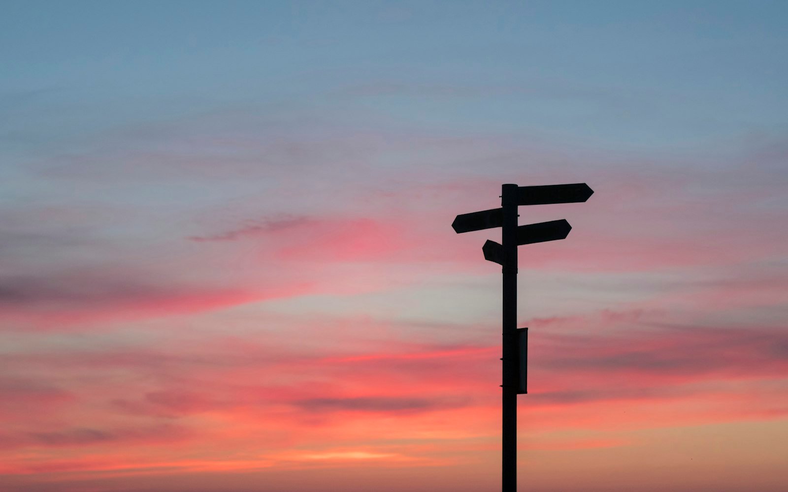 Silhouette of road signage during golden hour