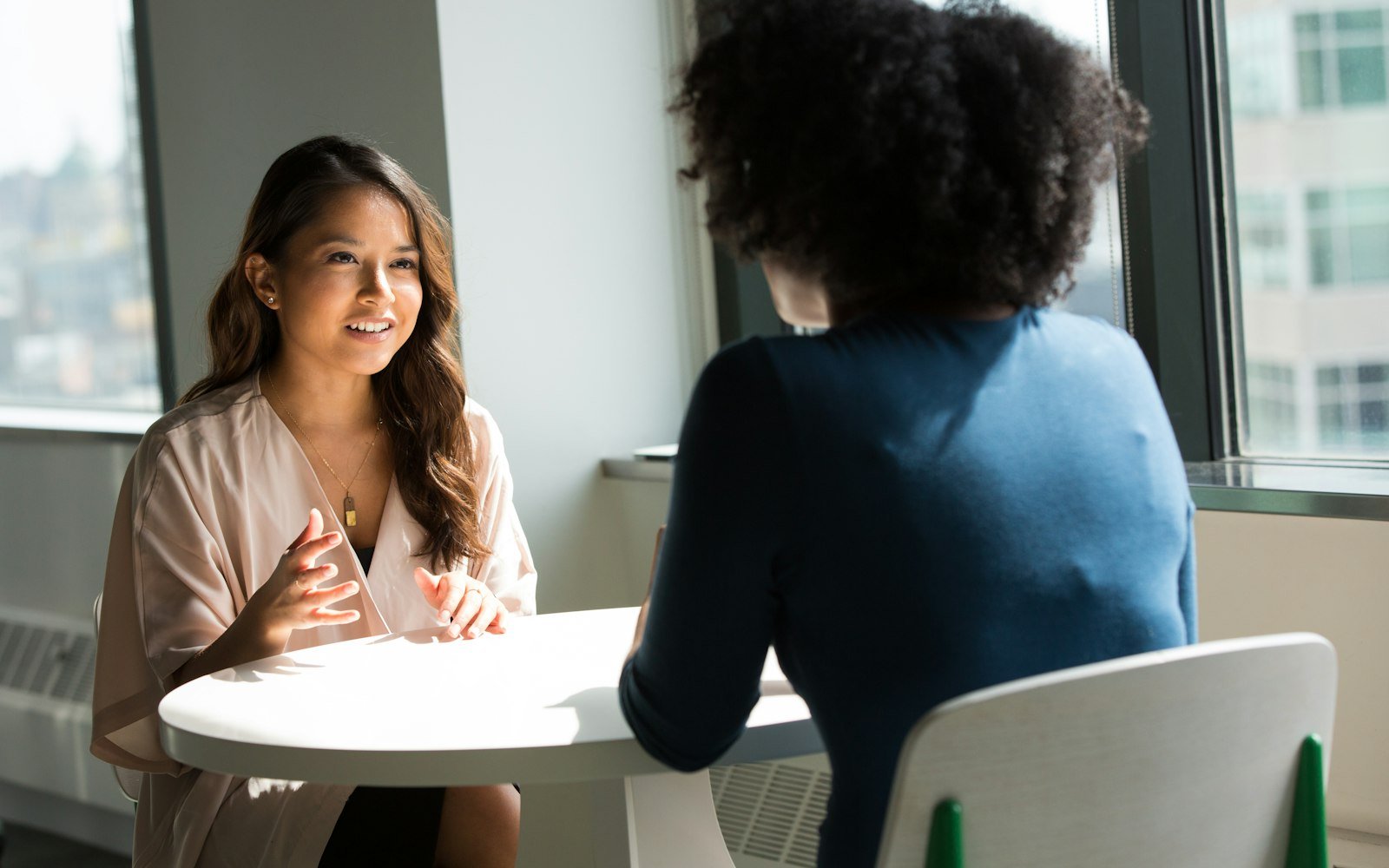Two women sitting on chair
