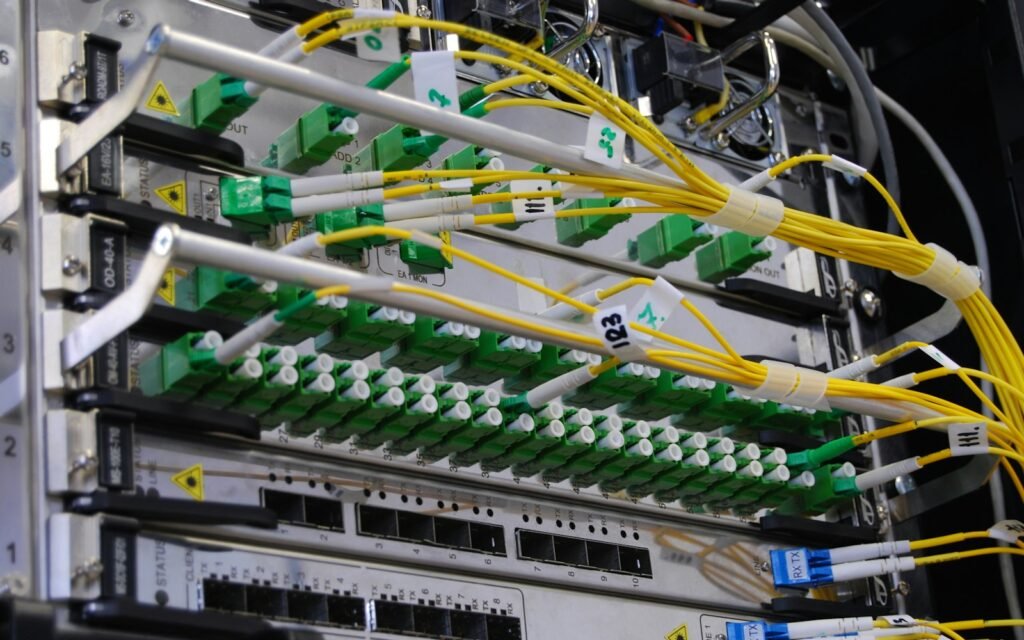 Fiber optic cables connected to a network switch in a server rack